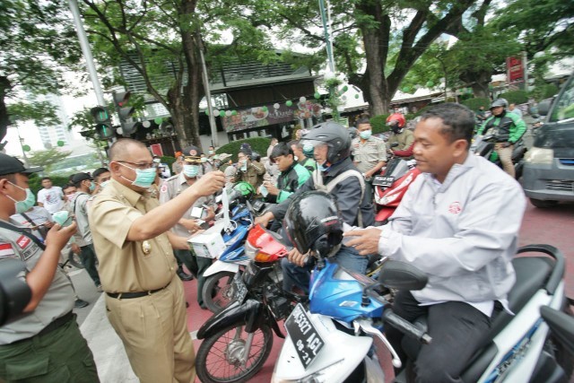 Plt Wali Kota Medan membagikan masker.(mimbar/ist)